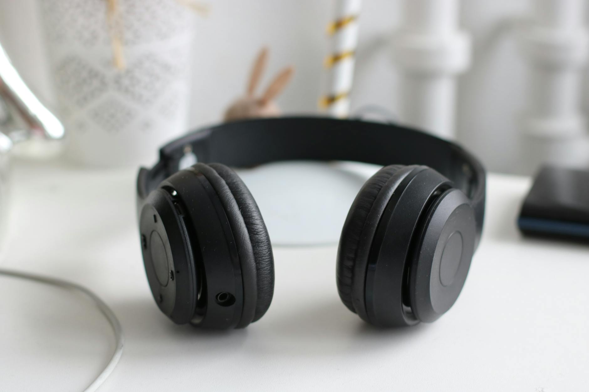 Premium over-ear wireless headphones resting on a desk surface