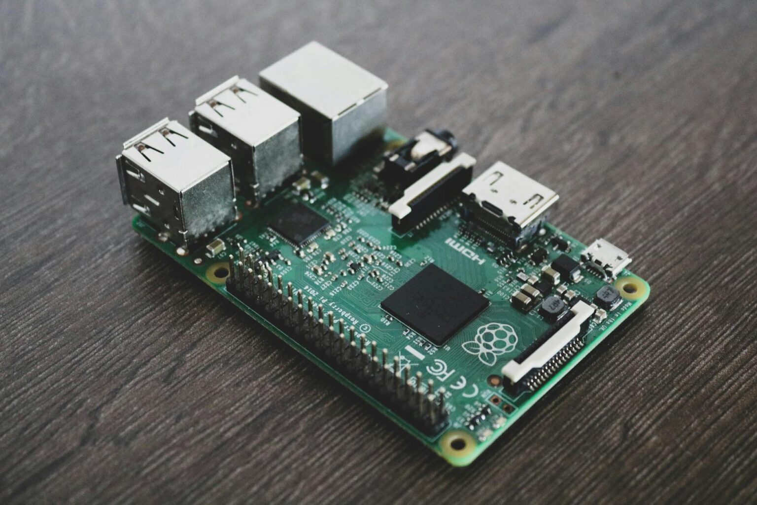 Raspberry Pi single-board computer connected to a network cable on a desk