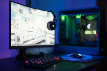 Modern computer workstation with multiple monitors displaying code and development environment