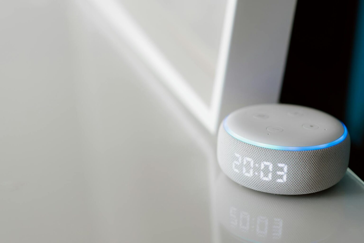 Modern smart home devices and control panel setup on wooden desk