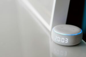 Modern smart home devices and control panel setup on wooden desk
