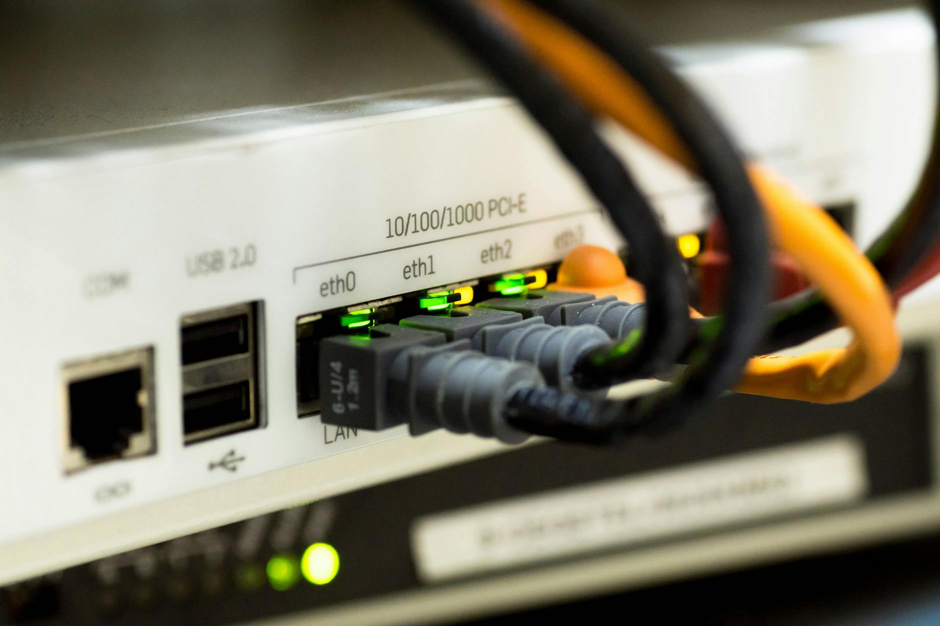 White wireless router with LED indicators in modern home office setting