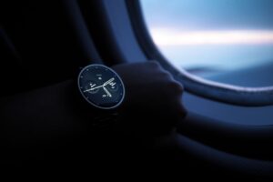 Close-up of a rugged smartwatch with titanium case on a rocky outdoor surface