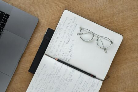 Set Up Obsidian Sync with End-to-End Encrypted Vault Sharing A laptop open on a desk with note-taking app visible on screen