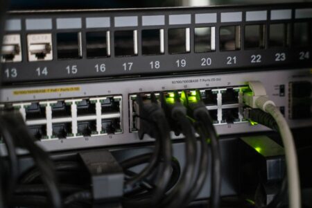 A home server rack setup with networking equipment and hard drives