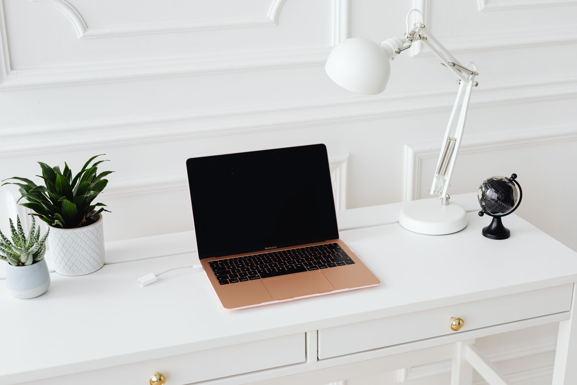 Clean minimalist home office setup with a tablet and notebook on a wooden desk
