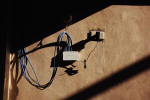 Set Up Pi-hole as a Self-Hosted Network Ad Blocker A home Wi-Fi router on a desk representing network DNS configuration