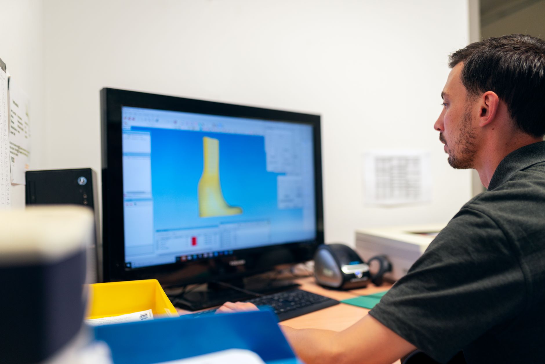 Close-up of a 3D printer nozzle laying down filament on a print bed