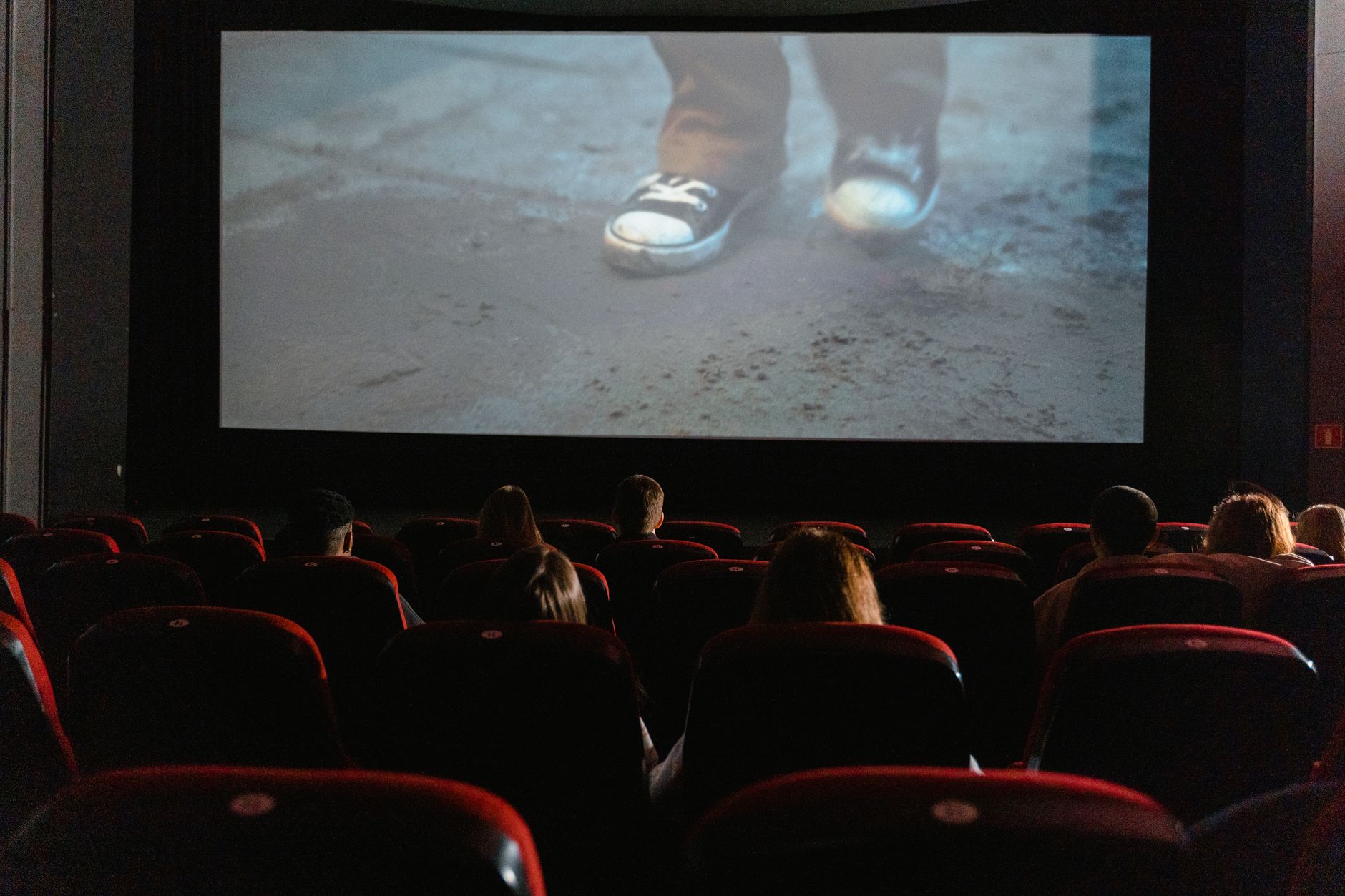 A television screen displaying a film with subtitles at the bottom