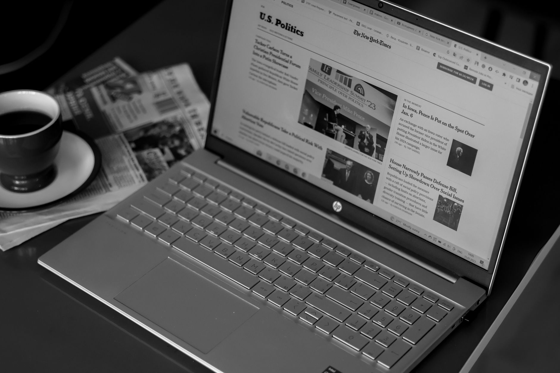 Person reading news articles on a laptop at a desk