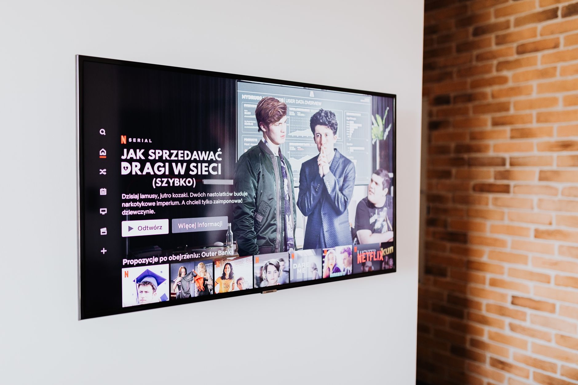 Person browsing a media streaming interface on a large television screen