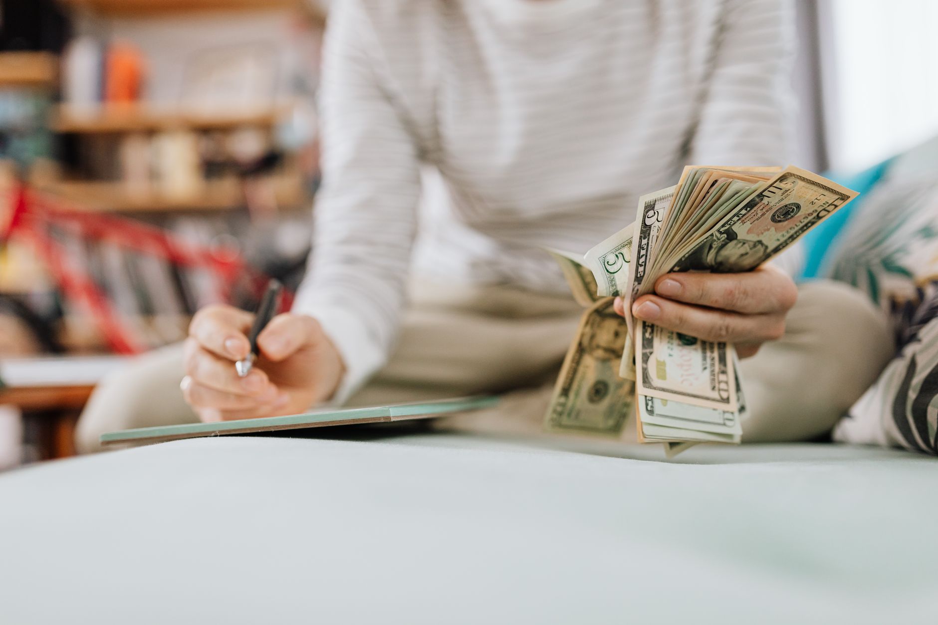 A person planning personal finances with documents and a calculator on a table