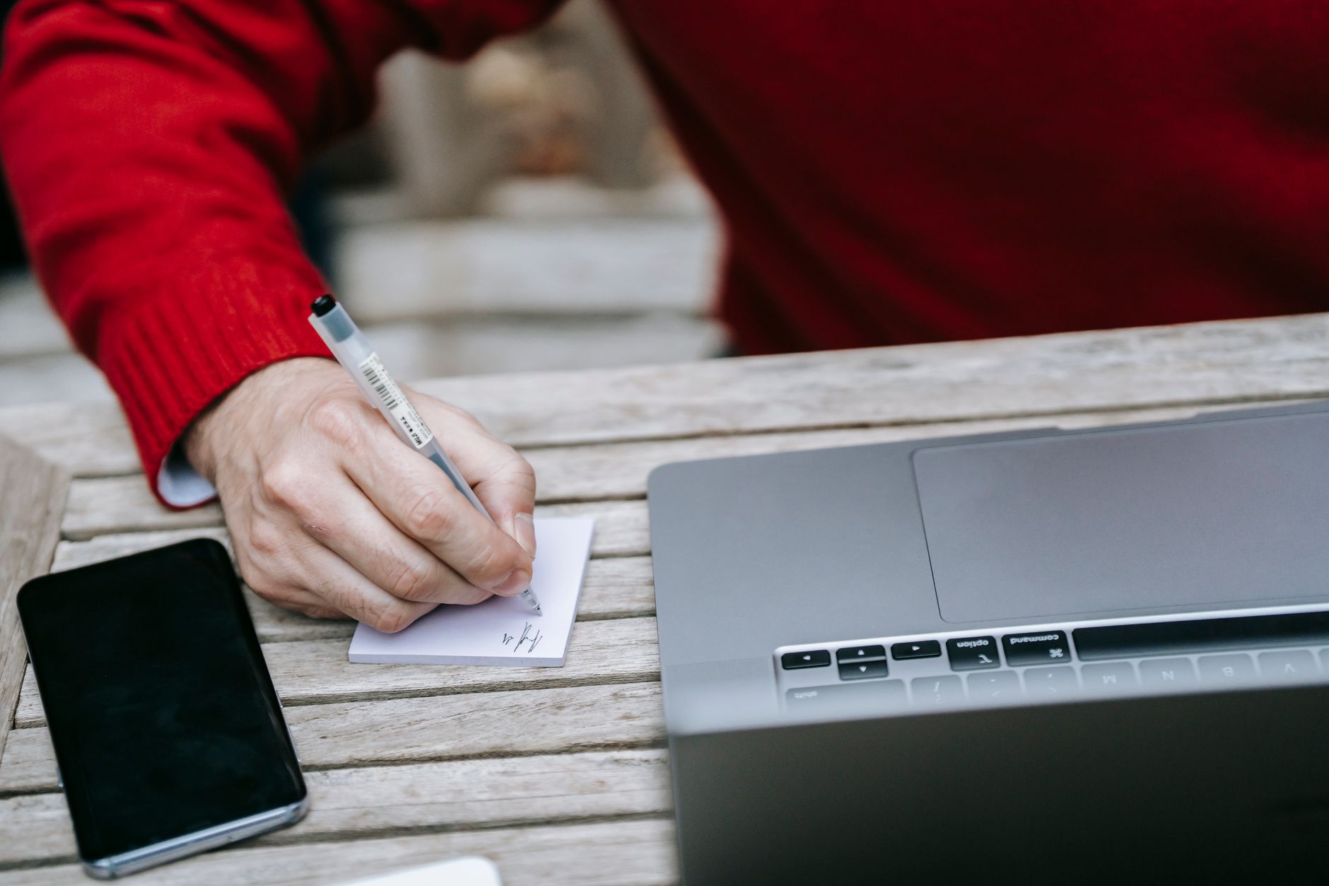 Person taking notes on a laptop representing synced note-taking across devices