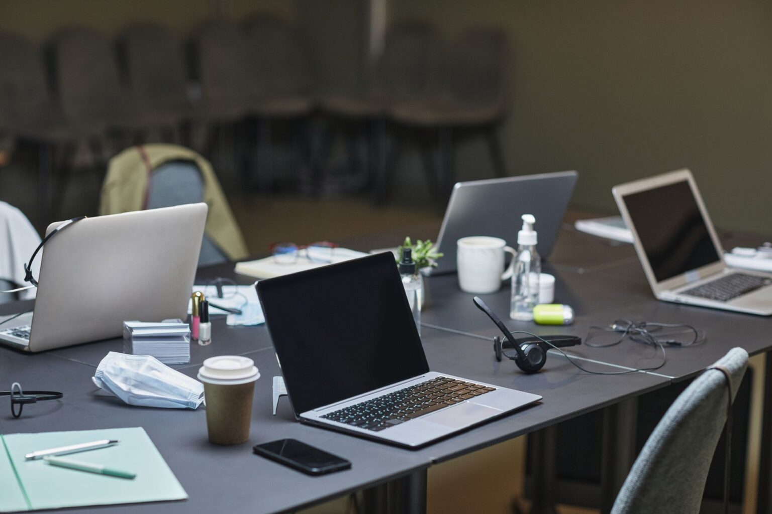 Multiple devices including a laptop and tablet on a clean desk, representing cross-device file synchronization