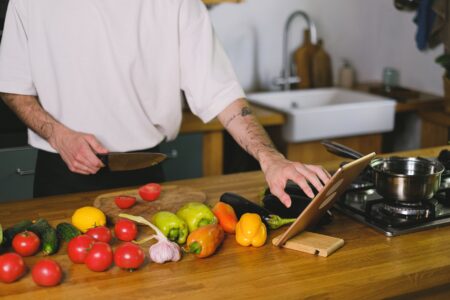 A tablet on a kitchen counter displaying a recipe app interface