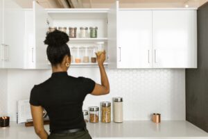 Organized pantry shelves with labeled food containers representing household inventory management