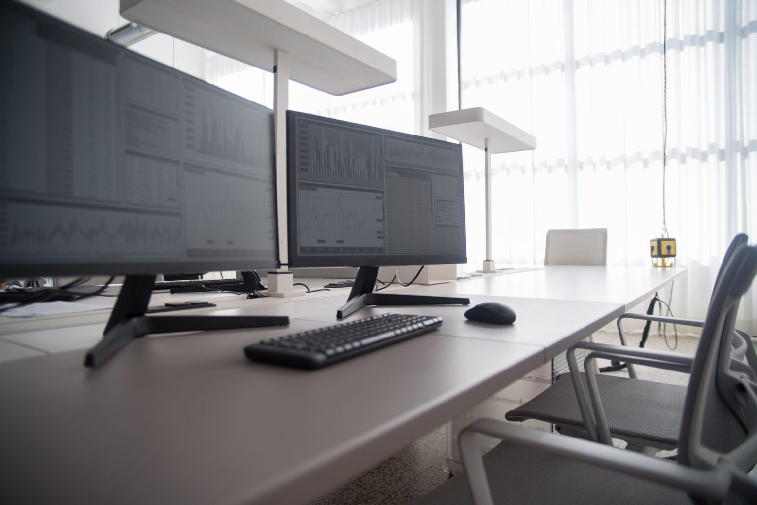 A designer working at a monitor with a UI design tool open on screen