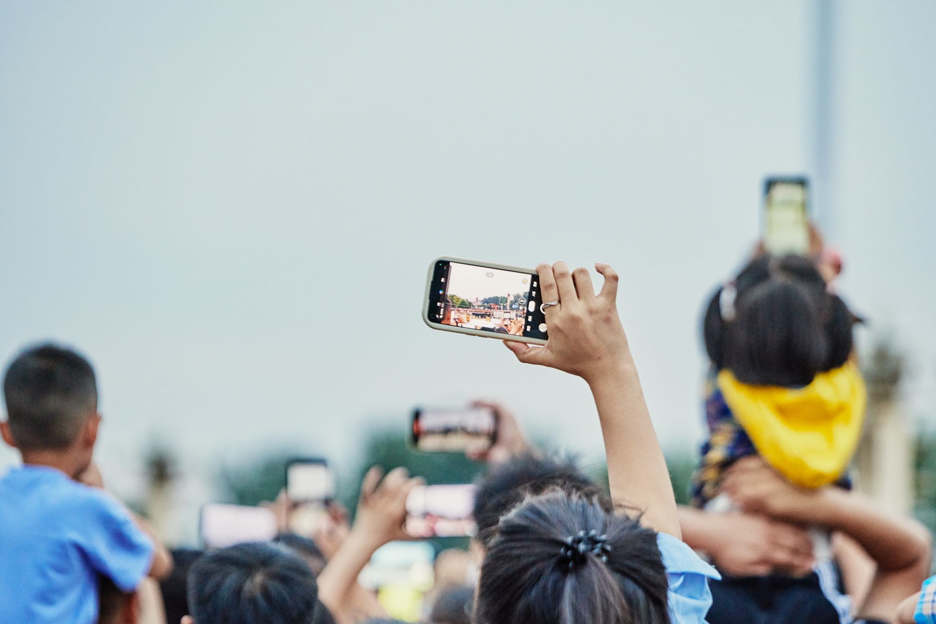 A smartphone syncing photos to a cloud or local backup system
